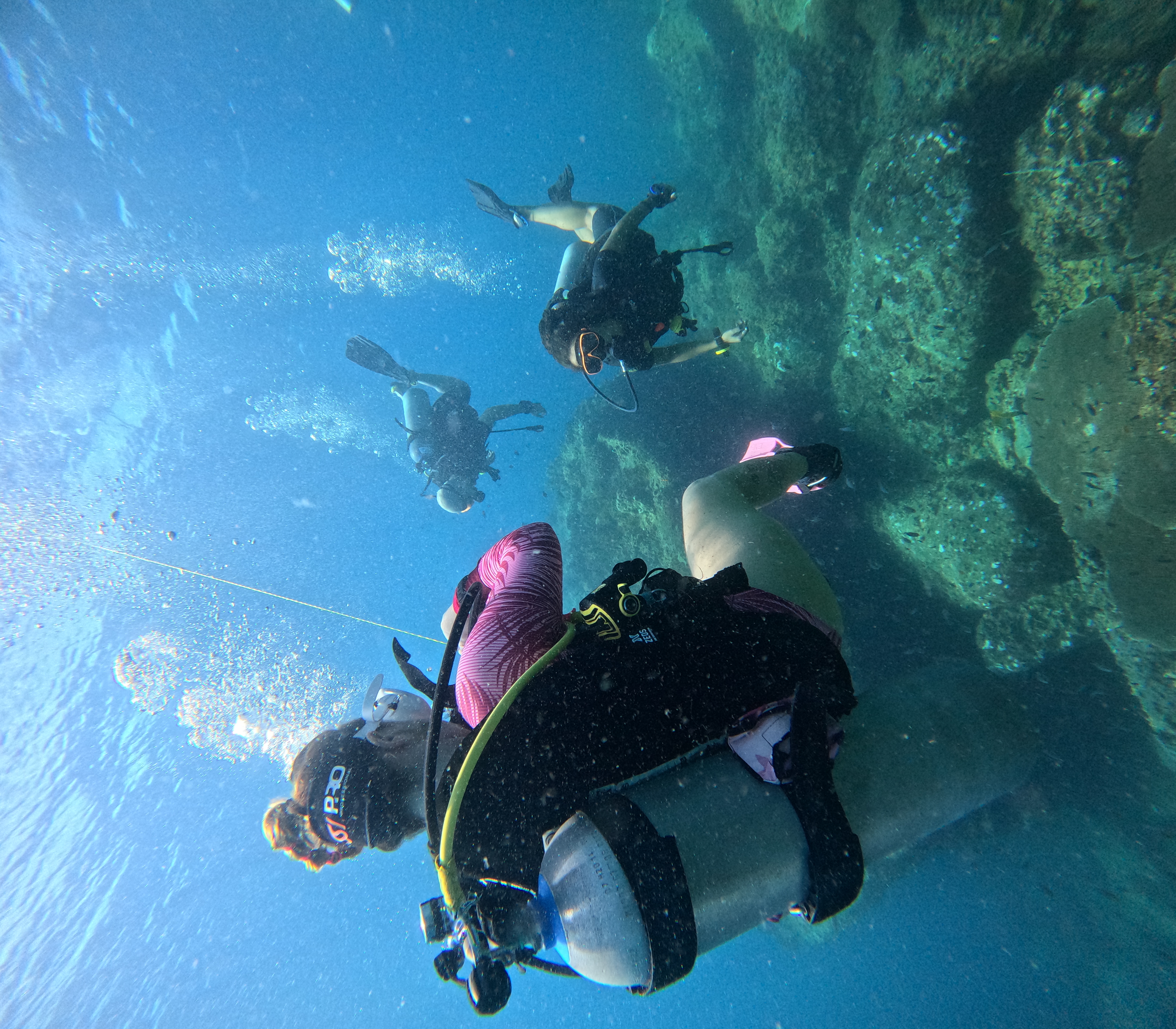 An instructor teaching new divers about scuba equipment on the beach at Carabao Diving Resort, Koh Tao