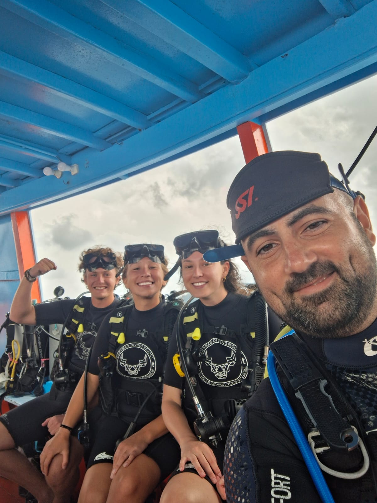 A boatful of happy divers from around the world after a dive at Carabao